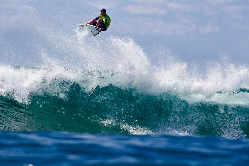 This is Joel Parkinson, famous power surfer, doing a very big air. Below you'll find Jordy Smith, famous aerial surfing, doing a power turn. ASP/Rowland